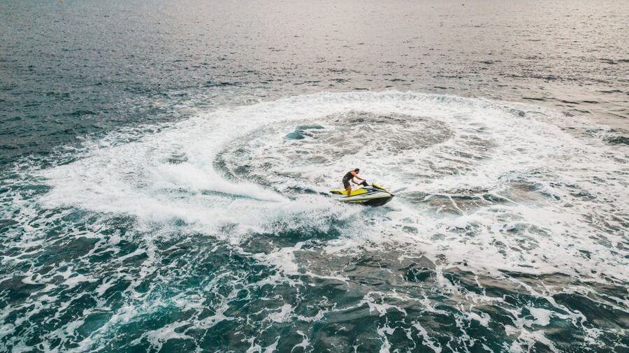 Mykonos: Super Paradise Beach Jet Ski, Canoe, & SUP Rental - Canoeing along the beach bay